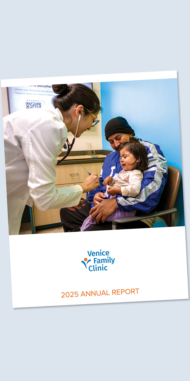 A Doctor Listens To A Toddlers Chest With A Stethoscope As The Child Sits On An Adults Lap In A Clinic Room. The Cover Reads Venice Family Clinic 2025 Annual Report.